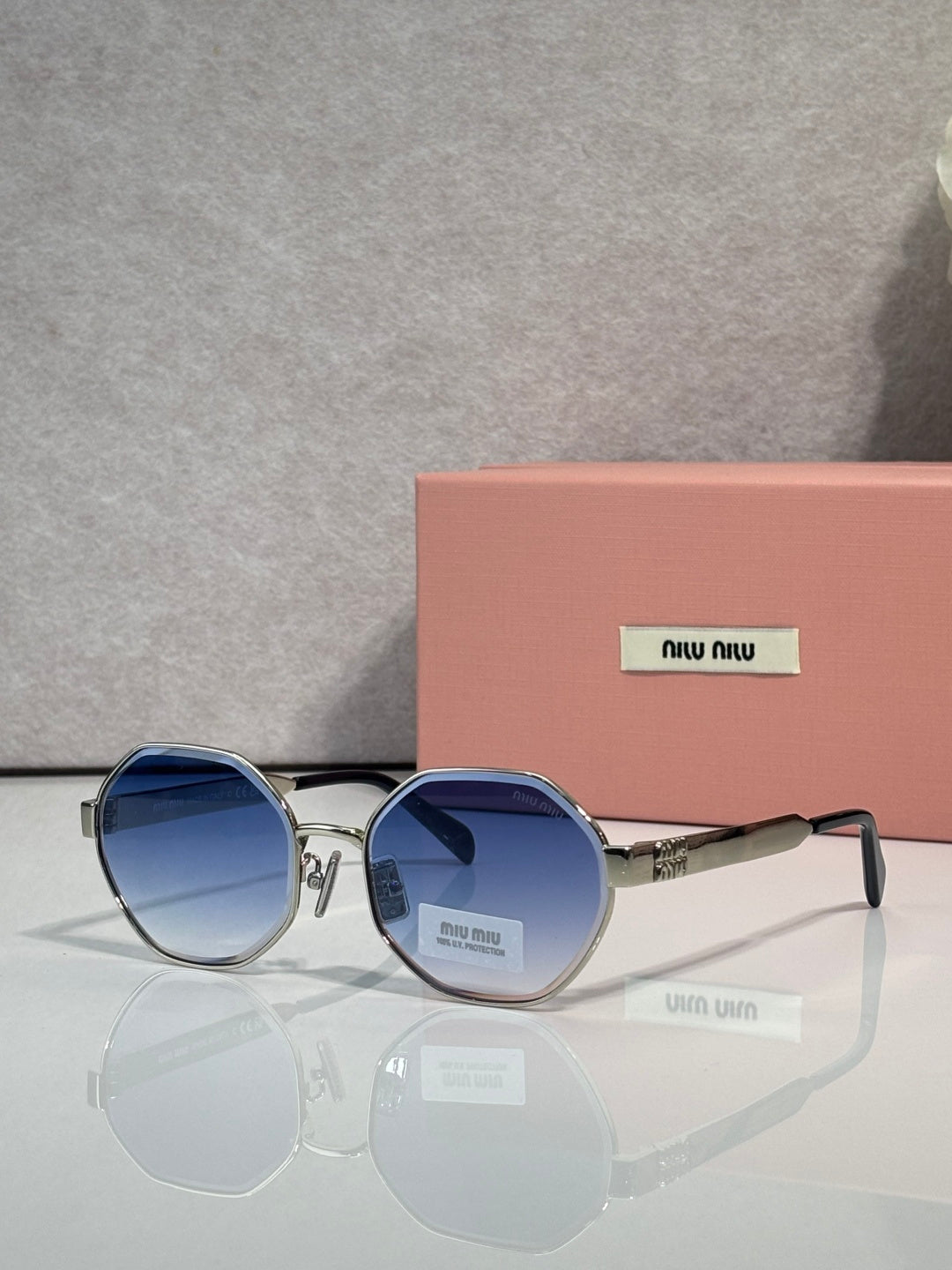 MiuMiu round sunglasses with navy tinted lenses and silver frame