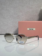 MiuMiu round sunglasses with dark tinted lenses and silver frame