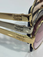MiuMiu sunglasses close-up of gold temples with engraved logo details