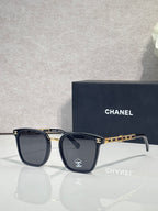 Chanel dark blue square eyeglasses with gold-tone chain detail on temples