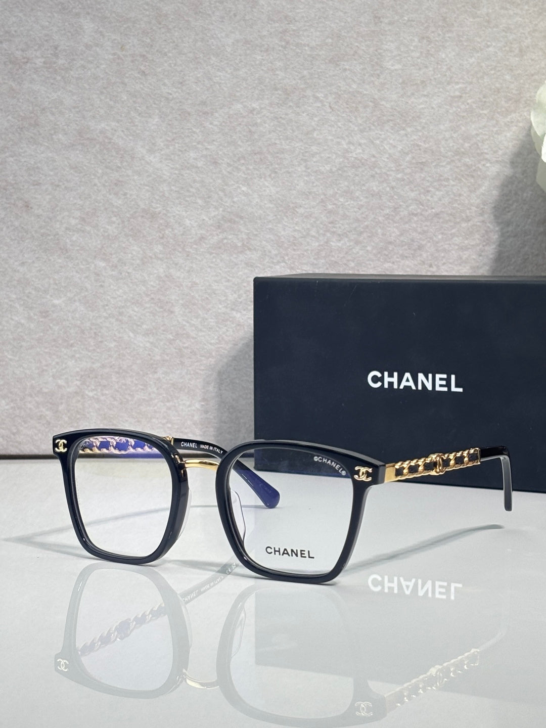 Chanel blue rectangular eyeglasses with gold chain link temple accents