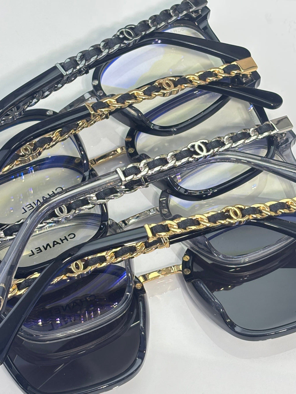 Chanel group of eyeglasses with dark blue frames and gold chain links