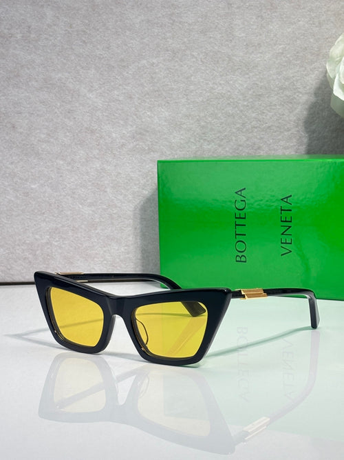 Bottega Veneta sunglasses with black frames and yellow tinted lenses