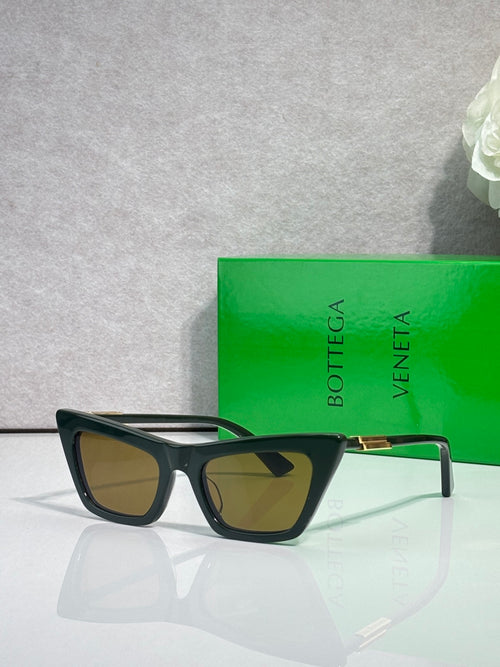 Bottega Veneta sunglasses, black frame with gold accents, brown gradient lenses