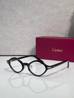 Round eyeglasses with dark blue-black frames and gold-tone bridge detail