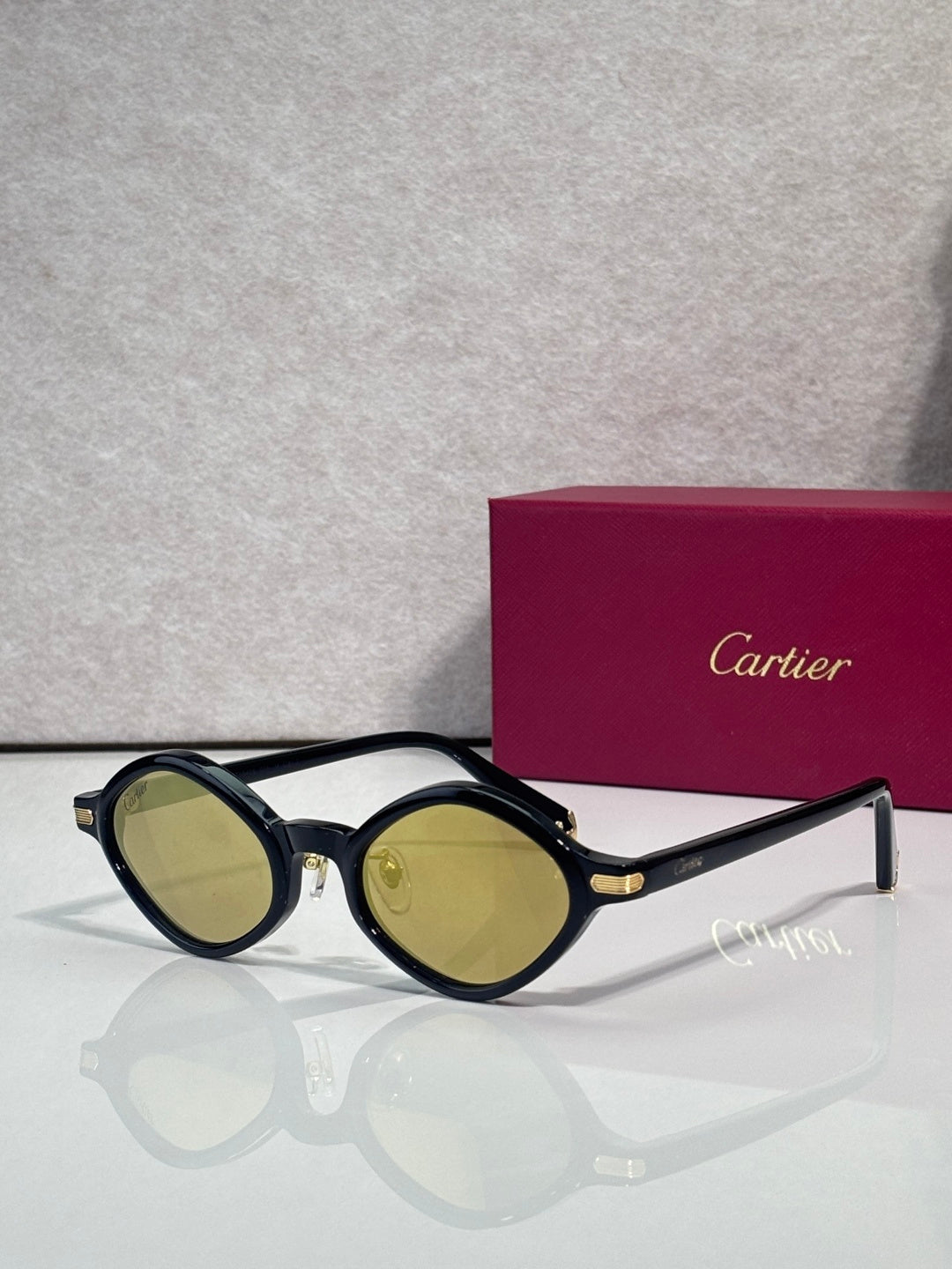 Round eyeglasses with dark blue-black frames and amber-tinted lenses