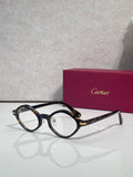 Round eyeglasses with dark blue-black frames and gold-tone temple accents