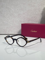 Round eyeglasses with dark blue-black frames and gold-tone temple accents
