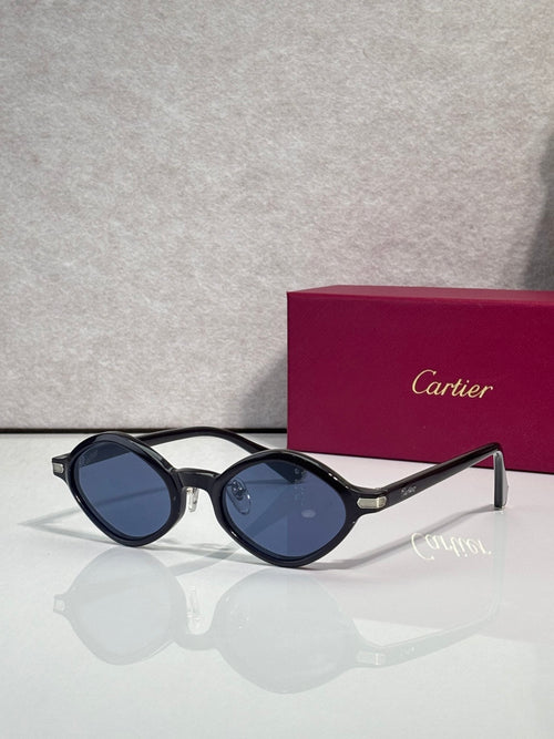 Cartier round sunglasses, dark frames with blue lenses, gold accents at the temples