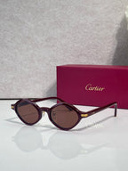 Cartier round sunglasses, burgundy frames, brown tinted lenses, gold detail at temples