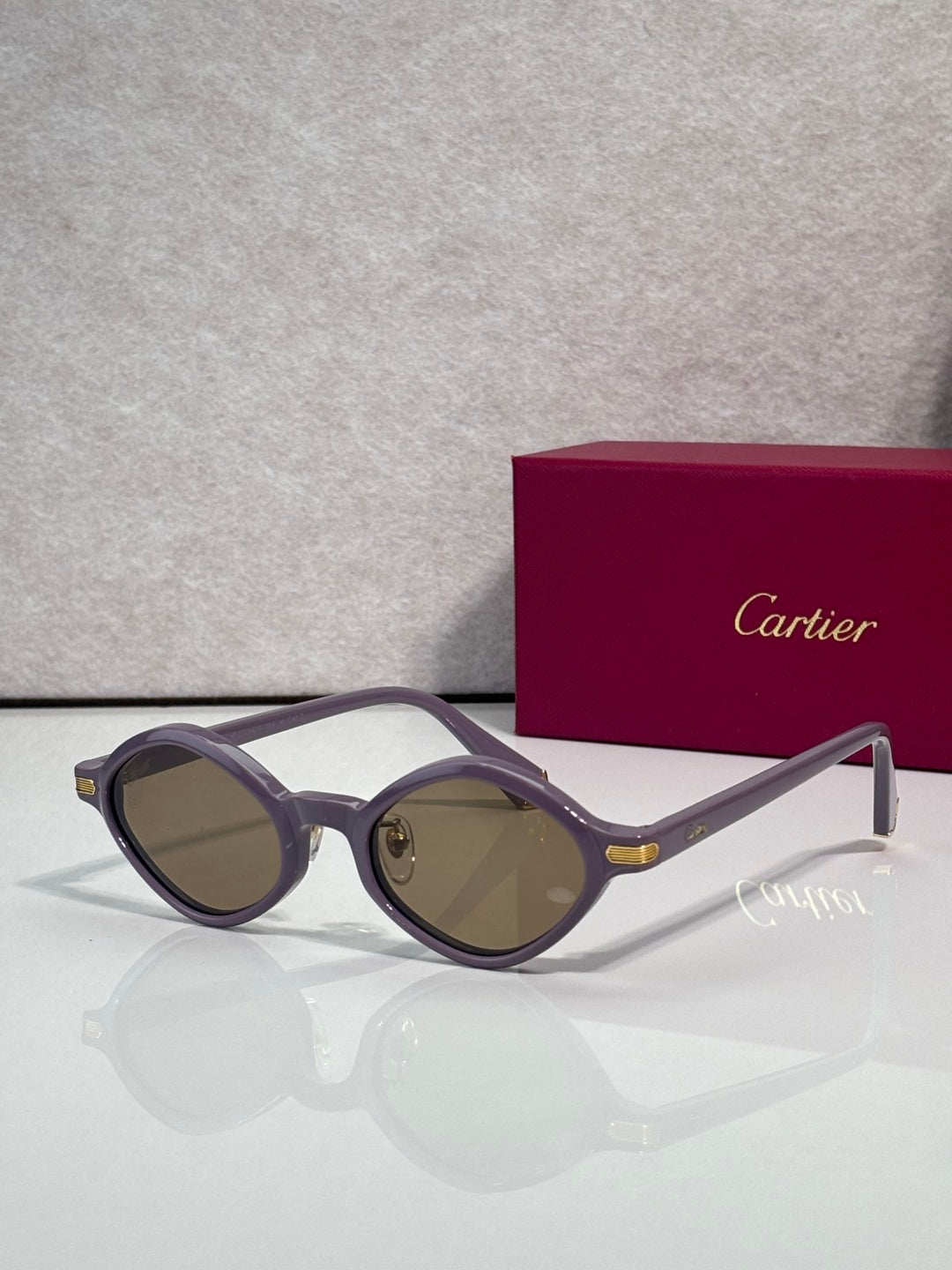 Cartier round sunglasses, purple frames, brown tinted lenses, gold detail at temples
