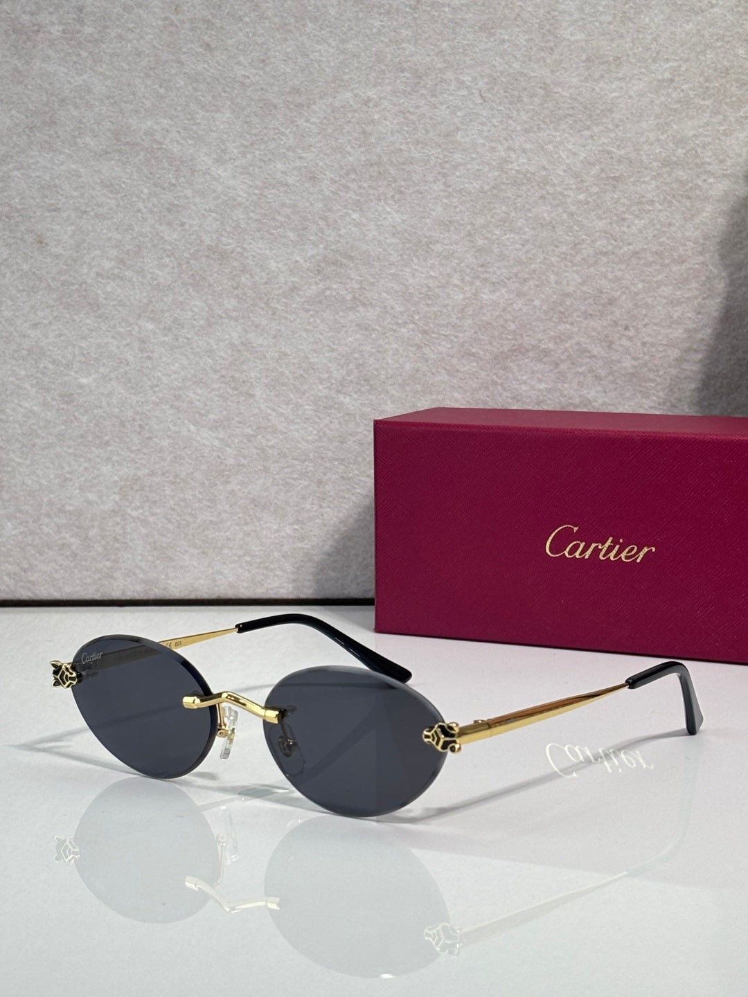 Dark round sunglasses with gold accents and black temples