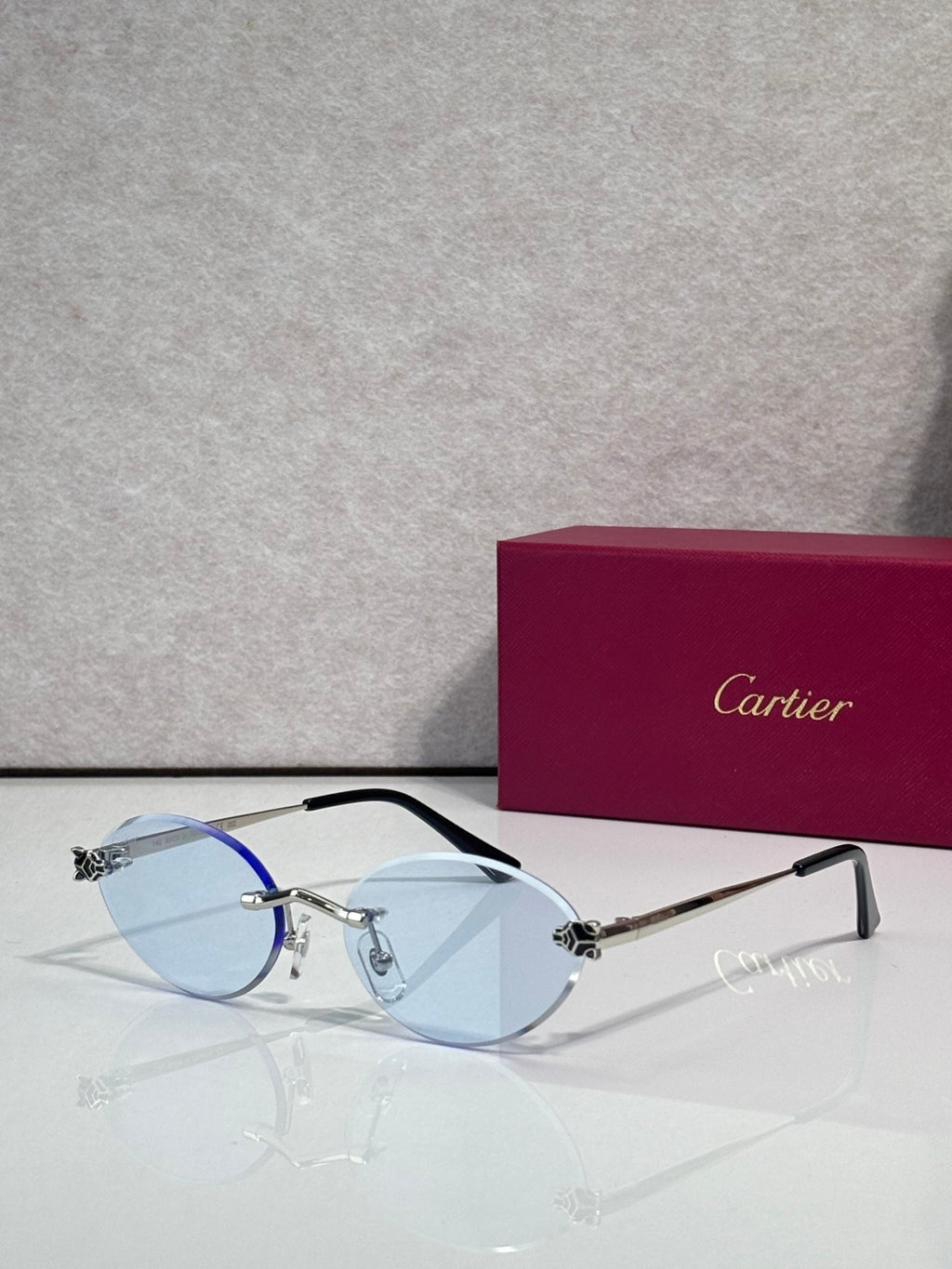Blue-tinted round eyeglasses with silver frame and black temples