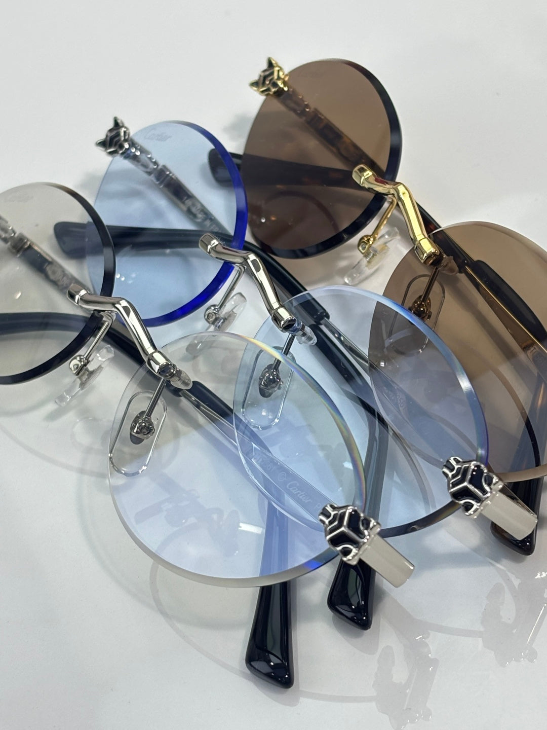 Multiple round eyeglasses with mixed blue and dark lenses and metal frames