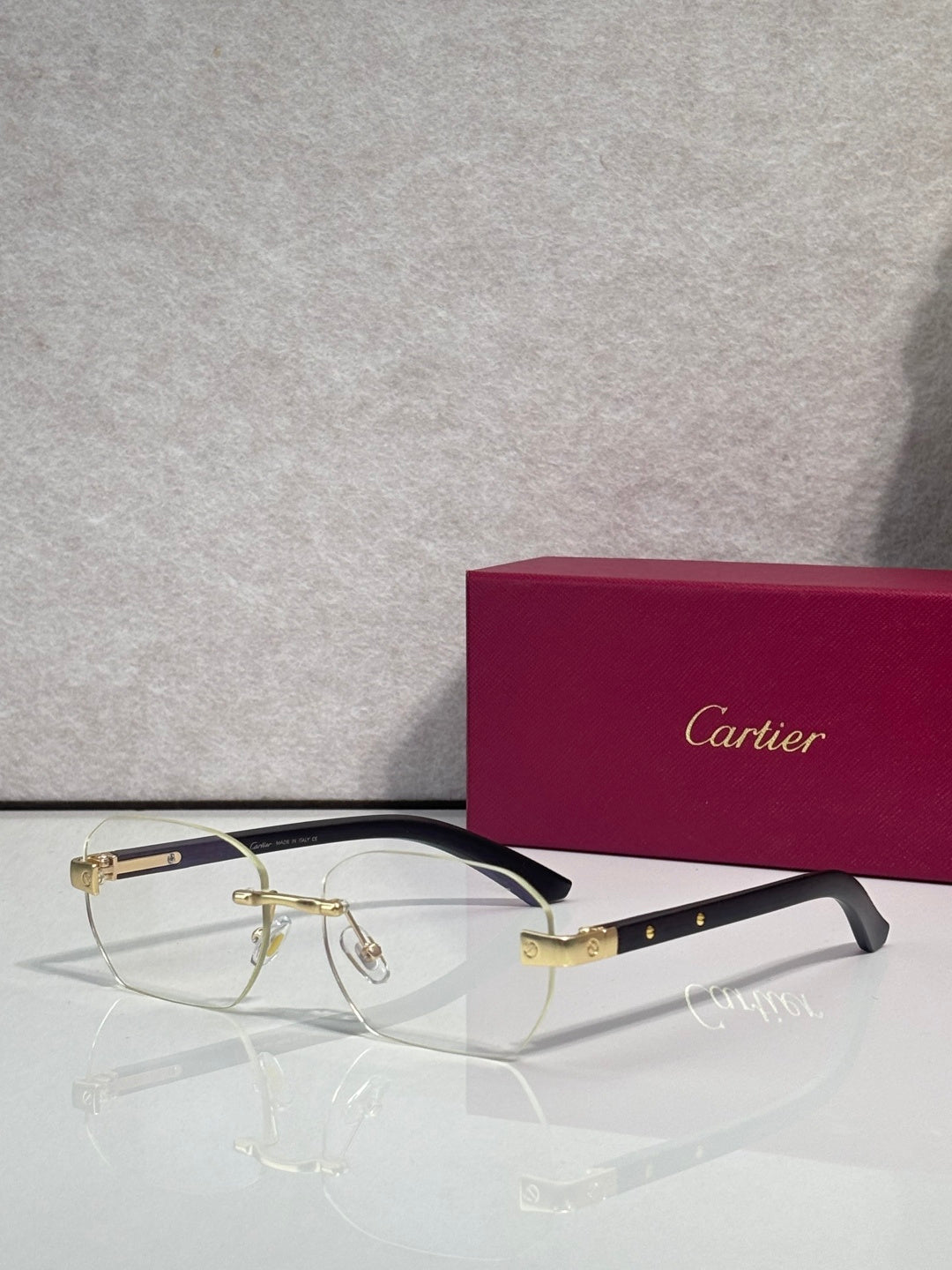 Cartier eyeglasses with clear frames and gold-tone accents, rectangular lenses