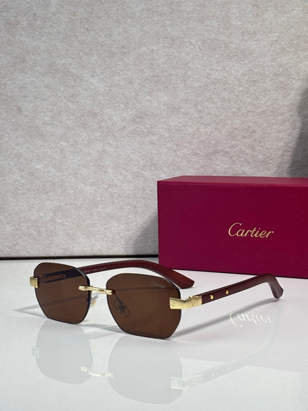 Cartier sunglasses with brown lenses, dark frame, gold-tone temples