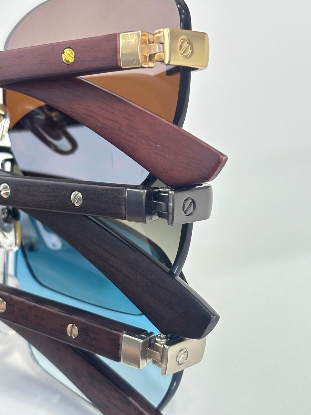 Cartier sunglasses close-up of wood-texture temples and gold-tone metal hinges