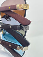 Cartier sunglasses close-up of wood-texture temples and gold-tone metal hinges
