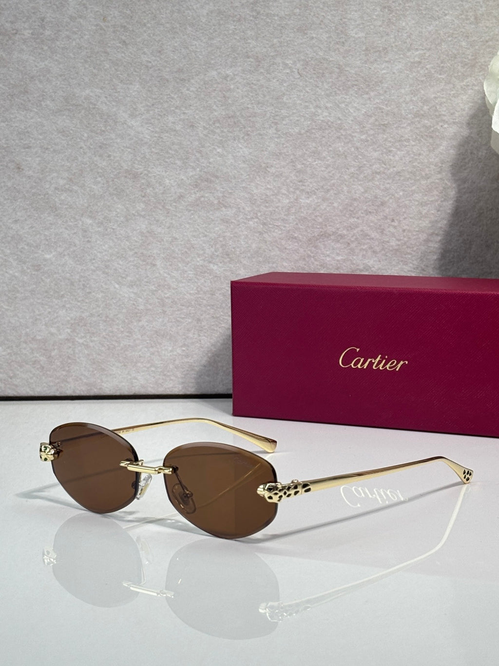 Cartier sunglasses with brown lenses and gold-tone metal frame, round face design