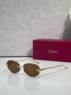 Cartier sunglasses with brown lenses and gold-tone metal frame, round face design