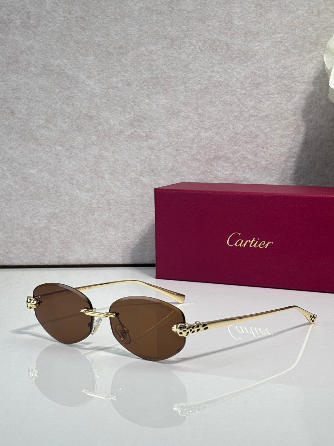 Cartier sunglasses with brown lenses and gold-tone metal frame, round face design