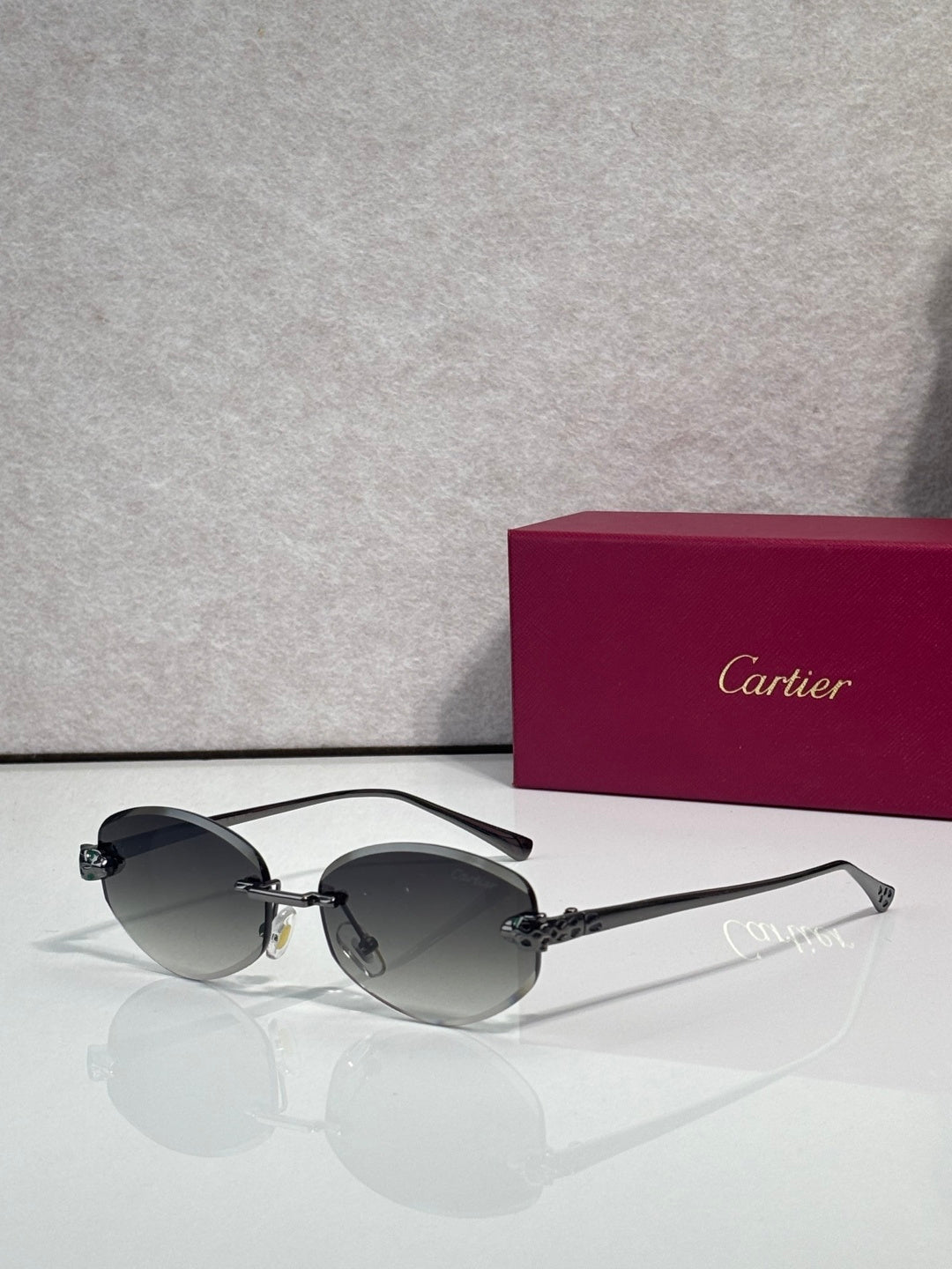 Cartier sunglasses with dark lenses and black metal frame, round shape