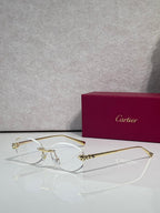 Cartier eyeglasses with clear lenses and gold-tone metal frame, round silhouette