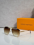 Louis Vuitton sunglasses with gradient dark lenses and gold-tone frames, side angle.