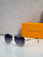 Louis Vuitton sunglasses with dark lenses and blue monogram-pattern frames, gold-tone hardware.