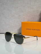 Louis Vuitton sunglasses with dark lenses and gold-tone round frames, side profile view.