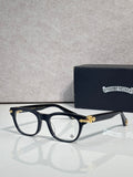 Eyeglasses with dark blue frames and clear lenses, gold bridge and temple accents
