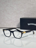 Eyeglasses with dark blue frames and clear lenses, gold bridge and temple accents