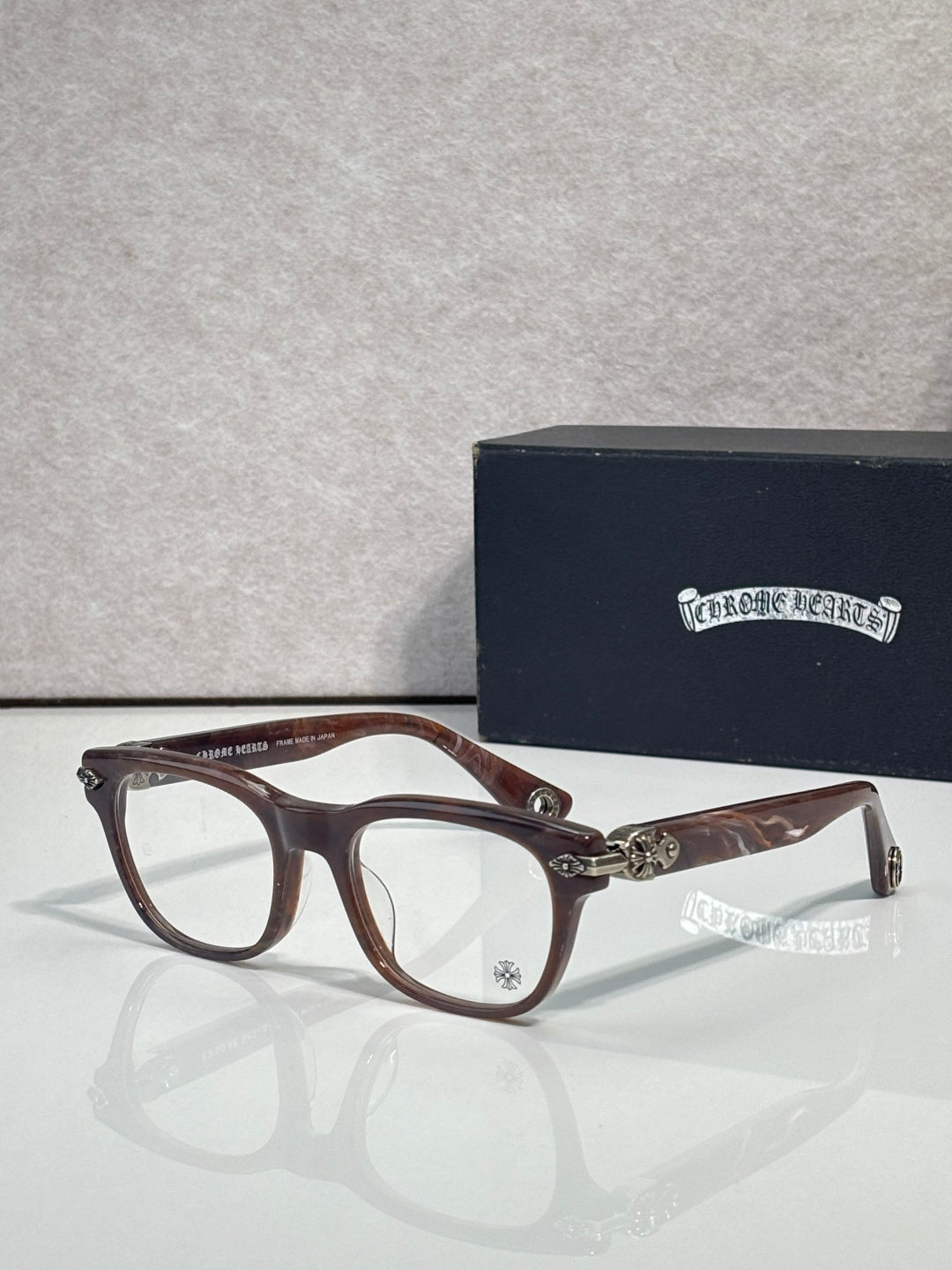 Eyeglasses with brown tortoiseshell frames and clear lenses, gold bridge and temple details