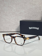 Eyeglasses with tortoiseshell frames and clear lenses, gold bridge ornament and temples