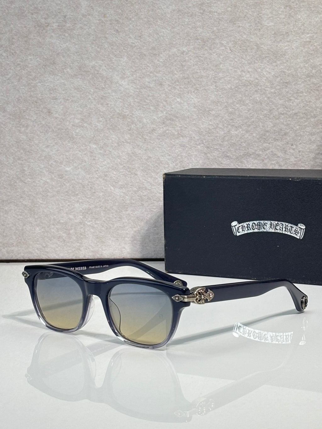 Blue sunglasses with mirrored amber lenses and gold-tone temple hardware