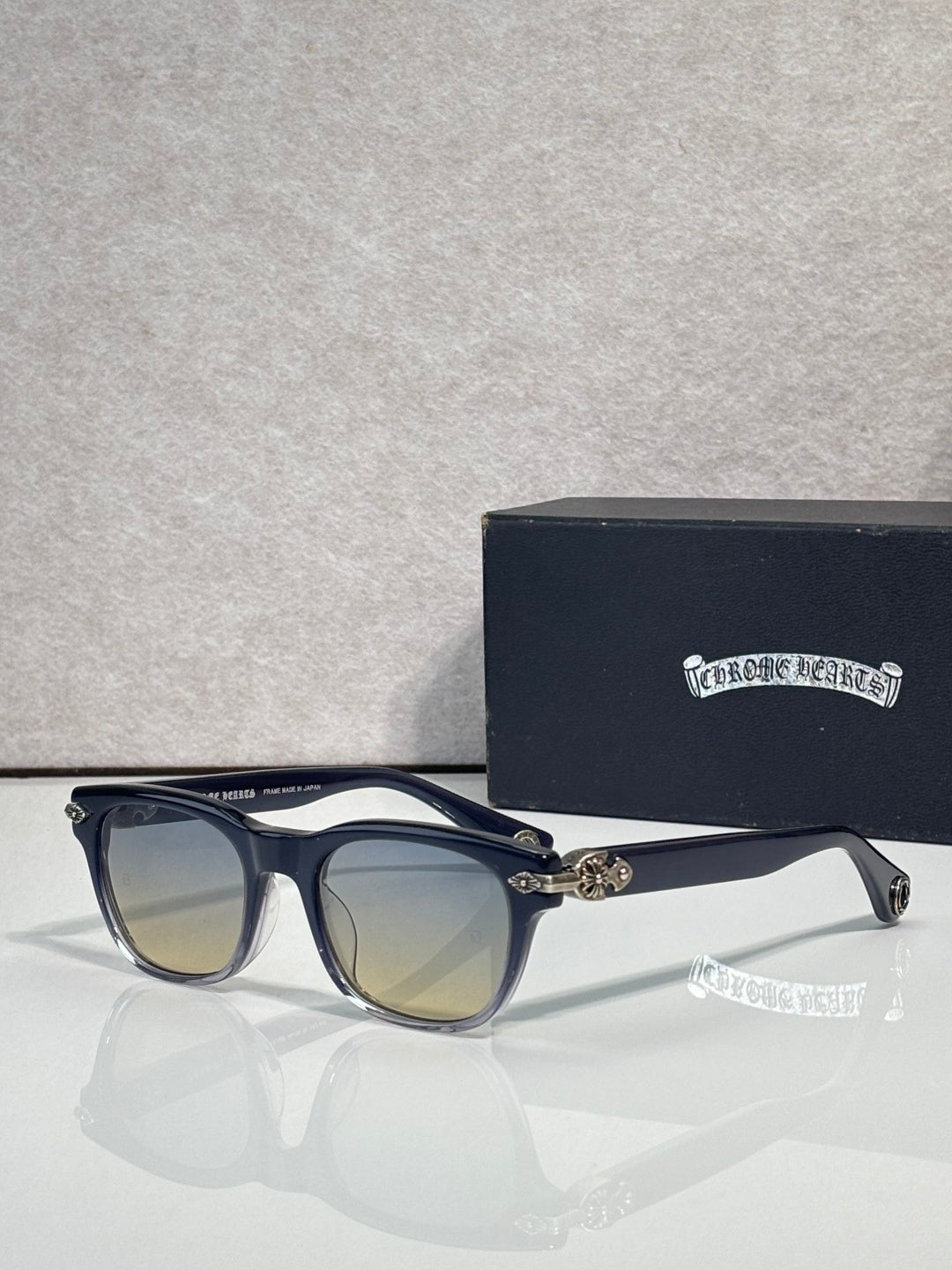 Blue sunglasses with mirrored amber lenses and gold-tone temple hardware