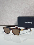 Dark tortoiseshell sunglasses with brown lenses and gold-tone temple centerpiece