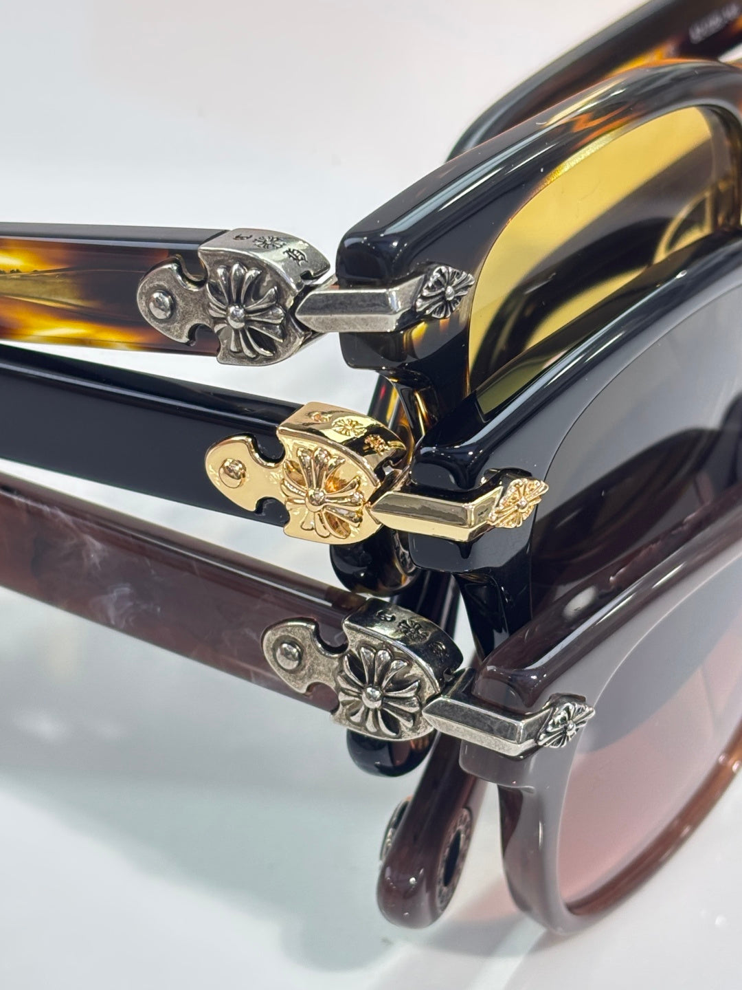 Close-up of tortoiseshell sunglasses temples with gold and silver floral charms