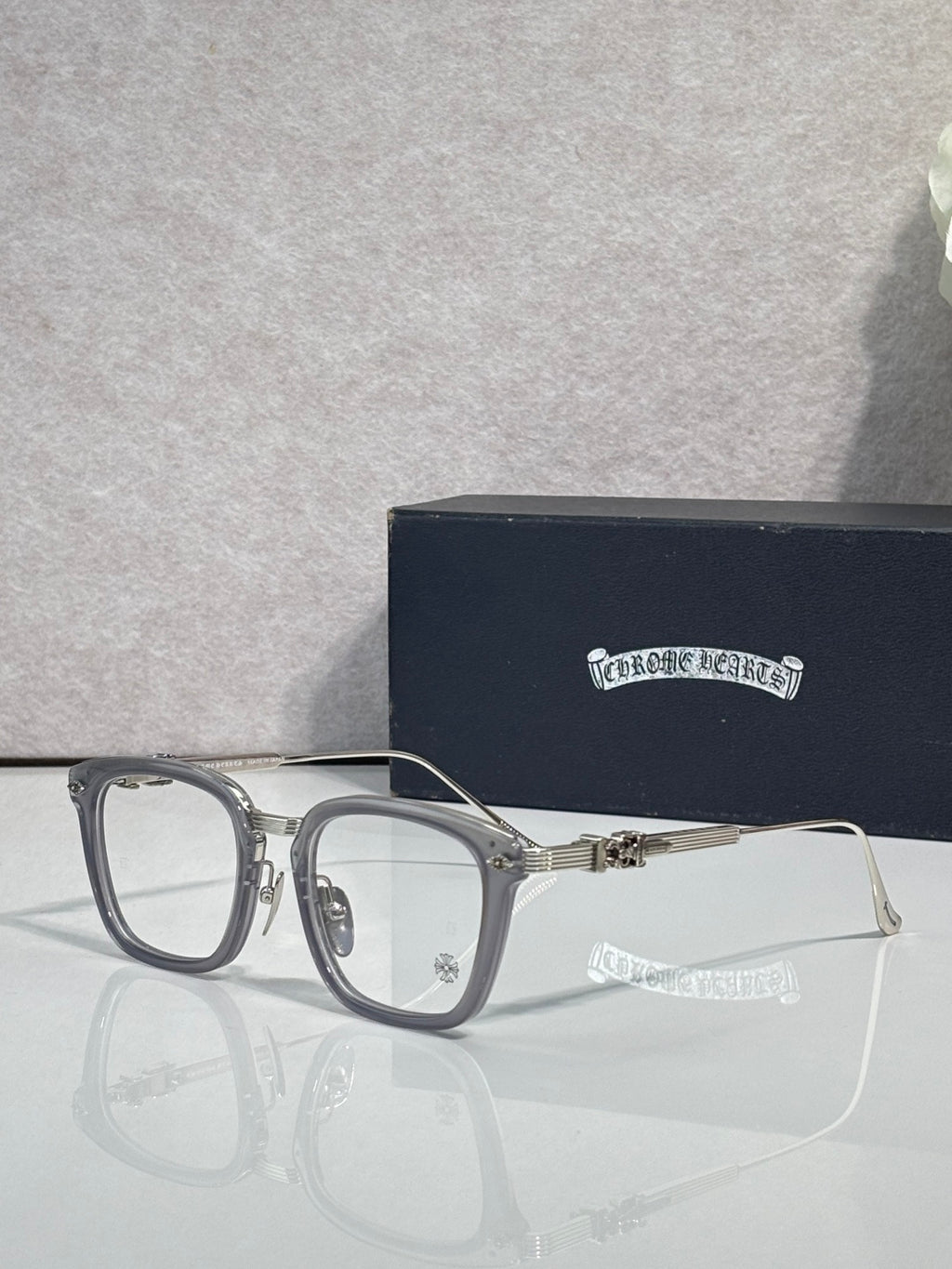 Silver-toned rectangular eyeglasses with clear lenses and metal bridge detail