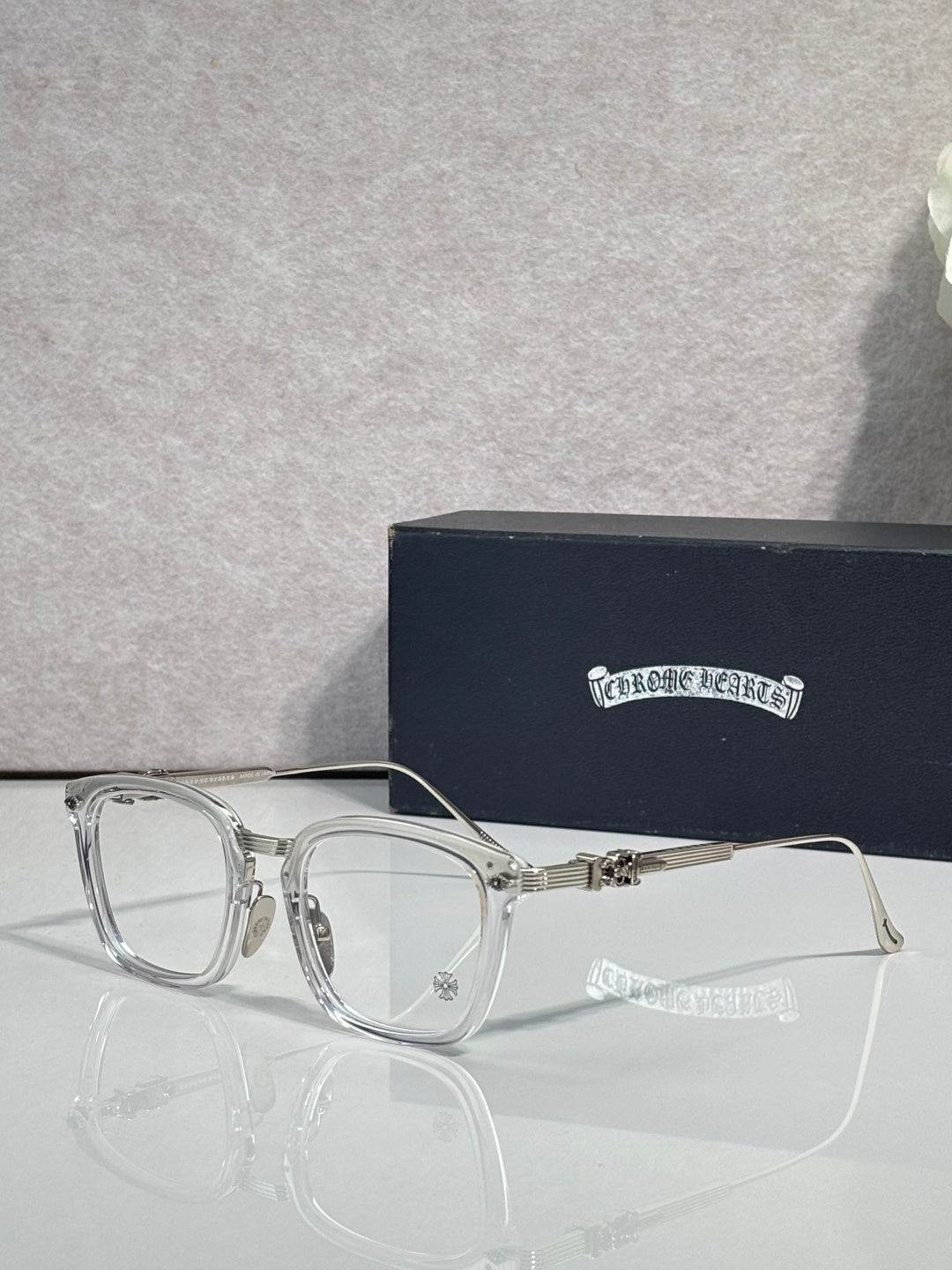 Chrome eyeglasses with rectangular clear lenses and silver-toned frames