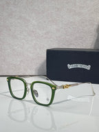 Green eyeglasses with rectangular clear lenses and gold-toned hinge accents