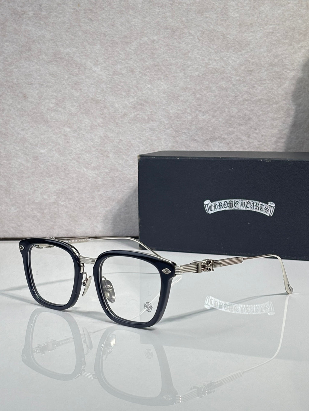 Chrome eyeglasses with dark frame edges and rectangular clear lenses