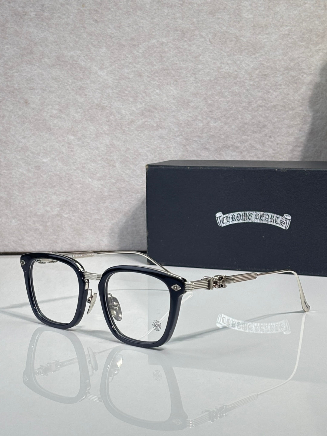 Chrome eyeglasses with dark frame edges and rectangular clear lenses