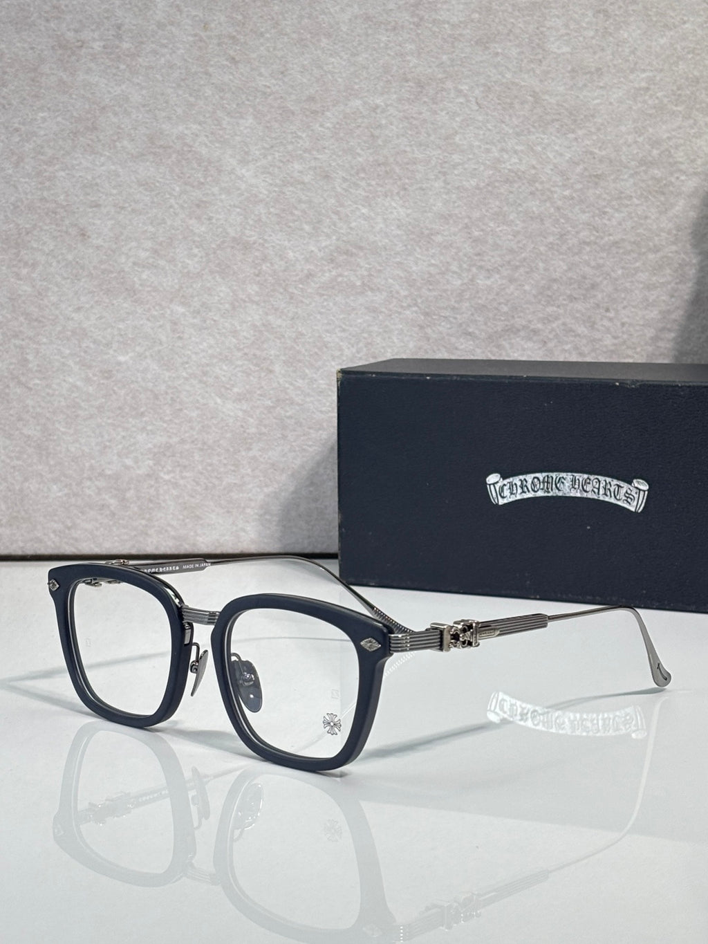 Navy eyeglasses with rectangular clear lenses and silver-toned metal arms
