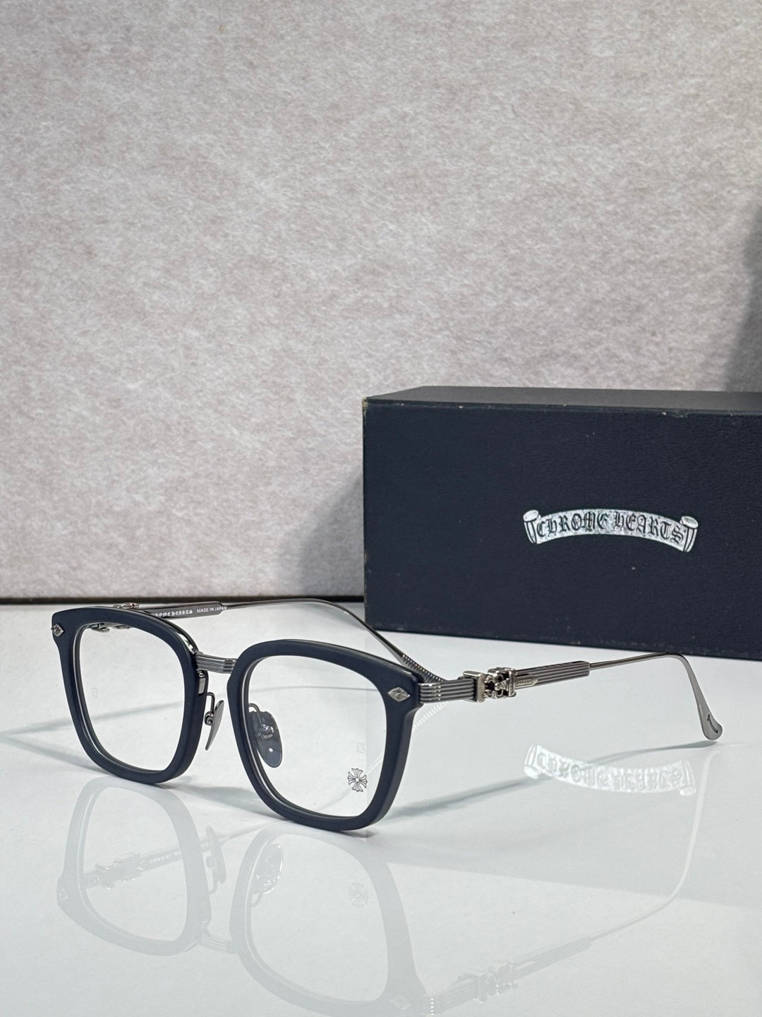 Navy eyeglasses with rectangular clear lenses and silver-toned metal arms