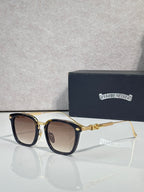 Square sunglasses with dark lenses, black frame, gold temple details, chrome trim