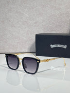 Square sunglasses with dark lenses, black frame, gold bridge and temple accents