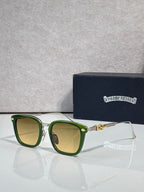 Square sunglasses with yellow-green lenses, green frame, gold bridge and chrome trim