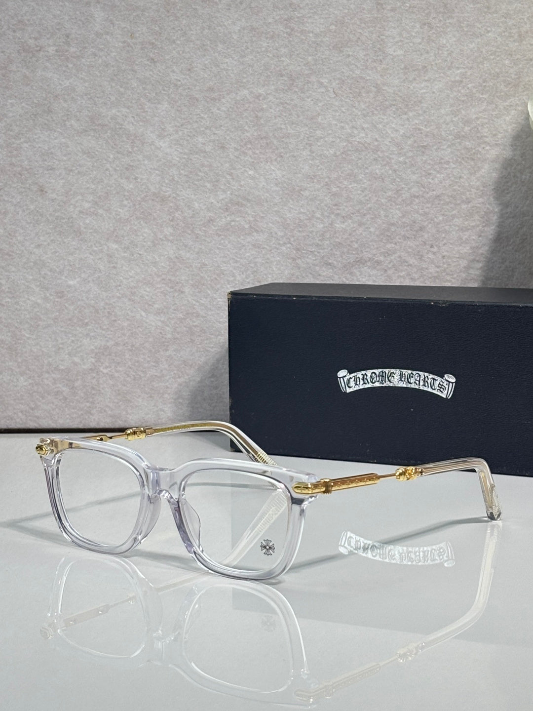 Clear eyeglasses with gold metal temples and rectangular frames