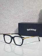 Dark eyeglasses with gold metal temples and rectangular frames